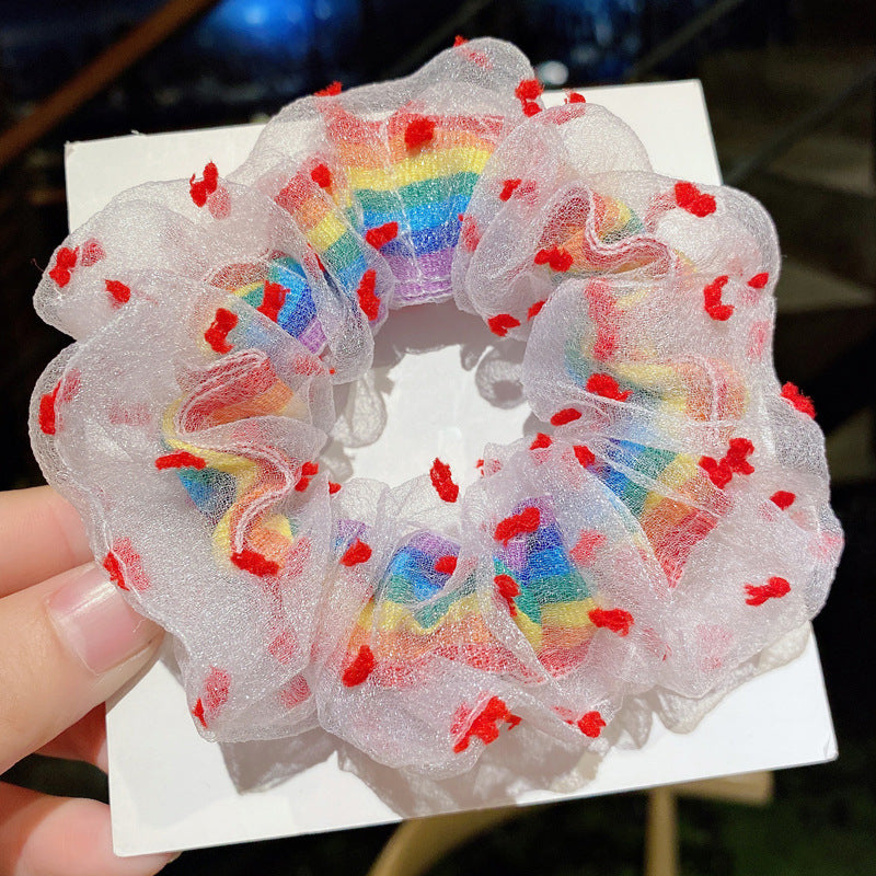 Red flowers around rainbow scrunchie